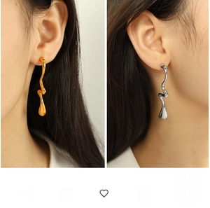 Exaggerated liquid metal earrings in gold and silver showing irregular wavy design