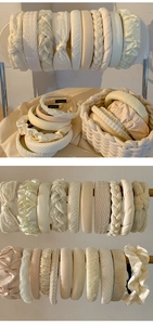 Detail of cream-colored headbands featuring satin, braided, and pearl textures