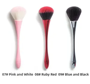Three large makeup brushes for powder and blush in pink, ruby red, and blue-black colors
