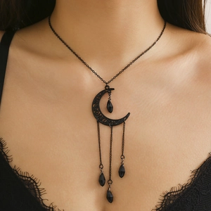 Detailed view of Gothic black crescent moon choker with teardrop beads on a model