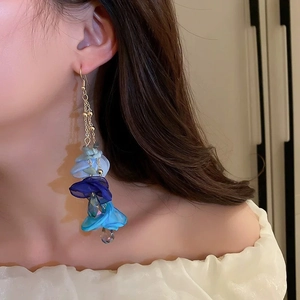 Elegant long blue gradient fabric flower earrings with pearls and gold chains on a model
