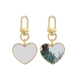 Sublimation gold heart-shaped keychain blank and printed sample on white background