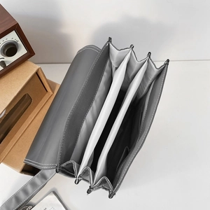 Minimalist vintage grey leather backpack showing interior compartments and sewing detail