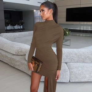 Detail of coffee-colored long sleeve dress featuring shirred side and asymmetric hemline