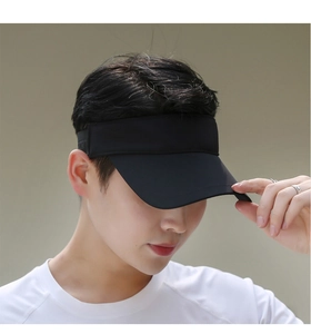 Close-up of a black sports sun visor worn by a model for outdoor summer activities