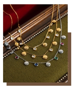 Detailed view of vintage shell pendants with colorful zircons on gold and silver chains