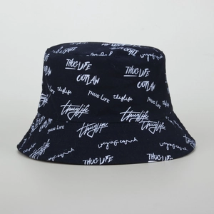 Detail of black cotton bucket hat featuring white graffiti lettering and fine stitching