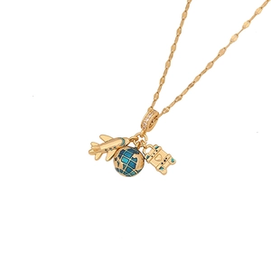 Gold necklace with airplane, enamel globe, and camera pendants on a white background