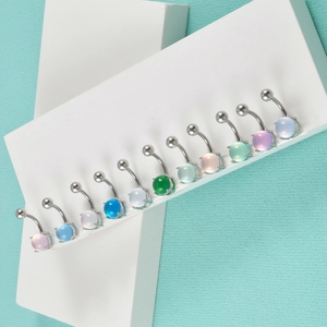 Detail of 12-piece colorful belly ring set with semi-round stones on 14G curved bars