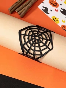 Detail view of a black spider web cuff bracelet on a pedestal for Halloween decor