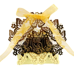 Elegant gold laser-cut butterfly gift box with ribbon for wedding favors and candies