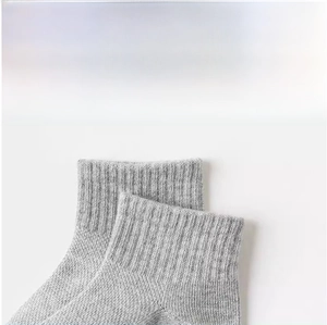 Detail showing the elastic ribbed cuff of grey cotton blend baby socks for comfort