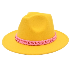 Detail of yellow wool felt fedora featuring a bold pink chunky chain decorative band