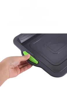 Detail of gray brownie pan handle with green anti-slip silicone textured grip
