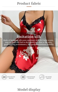 Detail showing the red imitation silk fabric with black lace trim and white floral pattern