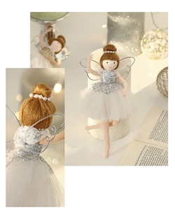 Detail of white plush ballet girl ornament with sequin wings in a cozy home setting
