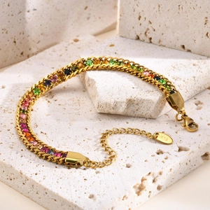 Detail of gold chain bracelet with rainbow cubic zirconia and K18 hallmark tag