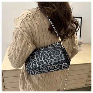 Chic leopard print shoulder bag for women with gold hardware shown on models shoulder