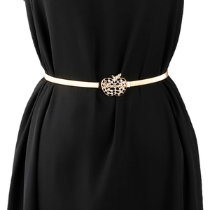 Détail de la boucle pomme dorée avec strass sur une ceinture élastique à ressorts