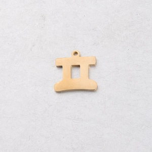 Detailed macro of a 15mm gold-plated stainless steel Gemini zodiac charm for DIY jewelry