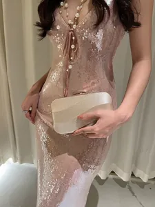Elegant champagne gold glitter clutch bag for women paired with a formal party dress