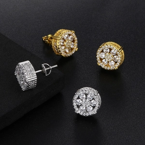 Macro detail of gold and silver hip hop earrings with micro-paved cubic zirconia stones