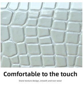 Close-up of premium light grey leather with embossed stone texture and smooth finish