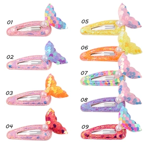 Detail view of colorful sequin mermaid tail hair clips for girls with pearl accent