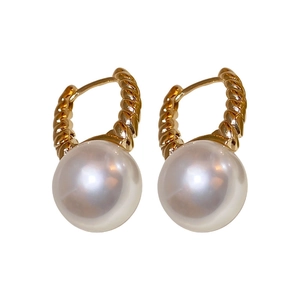 Elegant gold twisted wire earrings with large white round pearls on white background