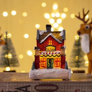 Detail of Toy Land Christmas miniature house with warm glowing LED light and snow texture