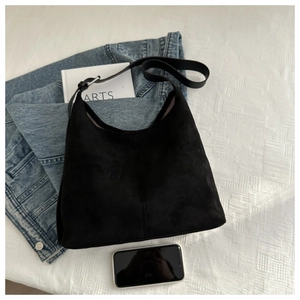 Detailed top view showing the large capacity and soft suede texture of the black tote bag