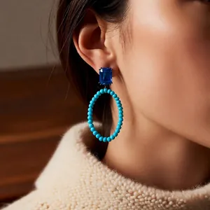 Vintage oval hollow earrings with navy gemstone and turquoise beads on model