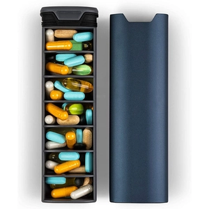 Detail of grey aluminum pill organizer with multi-compartment layers for weekly medication