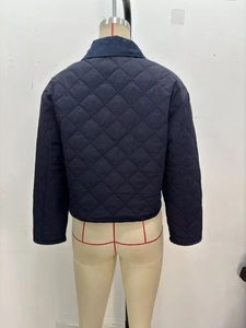 Rear view of deep blue diamond-quilted jacket with corduroy collar on a mannequin