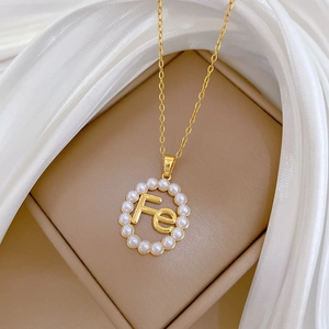 Elegant gold titanium steel necklace featuring hollow pearl pendant with Fe letter design