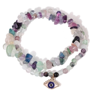 Detail showing multi-color gravel stone beads and blue evil eye pendant on an elastic bracelet