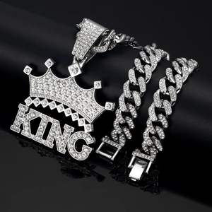 Close-up of iced out silver KING crown pendant and sparkling Cuban chain necklace