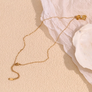 Macro detail of the 18K gold plated clasp and K18 engraving on the puppy heart necklace