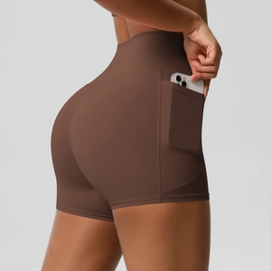 Close-up of high-waisted yoga shorts in dark brown with a functional side phone pocket