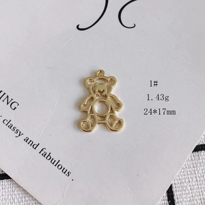 Macro shot of 24x17mm gold hollow bear pendant with weight detail on white background