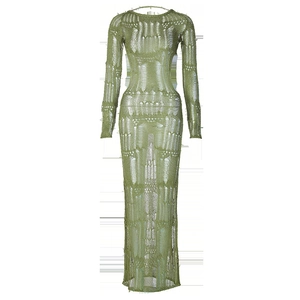 Detail of green knitted maxi dress featuring hollow out mesh texture and long sleeves