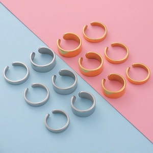 Polished C-shape open rings in gold and silver finishes on a dual-tone background