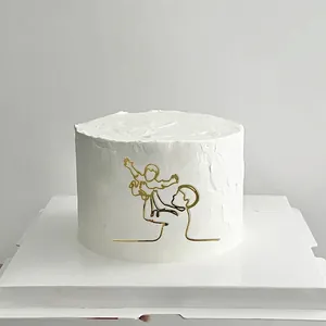 Detail view of 8.7cm gold acrylic cake topper showing a minimalist parent and child silhouette