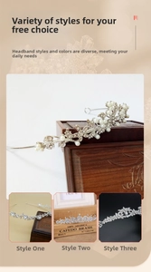 Detail of silver alloy tiaras with rhinestones and pearls on a vintage jewelry box