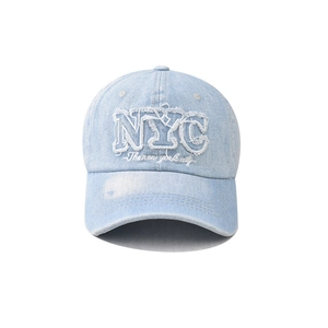 Detailed view of the washed light blue denim NYC embroidery and vintage frayed edges
