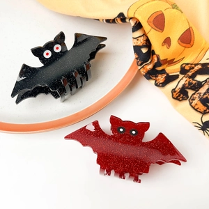 Halloween bat hair claws in glittery black and red acrylic with spooky eyeball accents