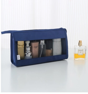Detail of dark blue travel toiletry bag with black mesh window and TRAVEL logo tag