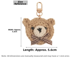 Detail view of a knitted bear keychain showing dimensions of 5.2cm width and 5.6cm length