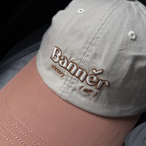 Detail of embroidered letters and premium stitching on two-tone cotton baseball cap
