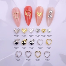 Macro view of alloy heart and crown nail charms with rhinestones and dimensions